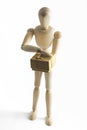 Wooden mannequin with a gift in hands Royalty Free Stock Photo