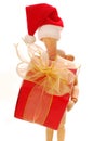 Wooden mannequin holding christmas gift box