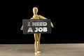 Wooden mannequin holding an I need a job sign Royalty Free Stock Photo