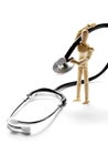 Wooden mannequin holding a stethoscope Royalty Free Stock Photo