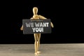 Wooden mannequin holding a we want you sign Royalty Free Stock Photo