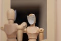 Wooden mannequin looking in mirror with blank white mask, identity crisis concept. Royalty Free Stock Photo