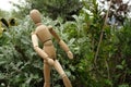 Wooden mannequin in the middle of Mediterranean. Garden with sea cinerary and rotating model