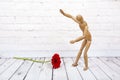 Wooden mannequin with red gerbera flower Royalty Free Stock Photo