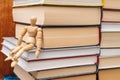 Wooden mannequin sit on the bookshelf