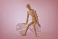 Wooden mannequin sitting on hourglass on pink background - Concept of stopping time, health and aging