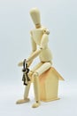 Wooden mannequin sitting in a house Royalty Free Stock Photo