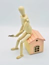 Wooden mannequin sitting in a house Royalty Free Stock Photo