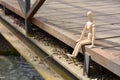 Wooden mannequin sitting