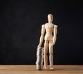 Wooden mannequin and stack of coins on a black background. Business growth concept Royalty Free Stock Photo