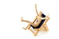 Wooden mannequin taking sunbath in deck chair Royalty Free Stock Photo