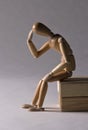 Wooden mannequin in thinking pose Royalty Free Stock Photo