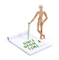 Wooden mannequin writing in scrapbook - Once upon a time