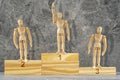 Wooden mannequins standing on the podium rank first three places Royalty Free Stock Photo