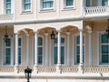 Wooden mansion close up detail. Beautiful classic architecture balcony with arch, columns and many windows