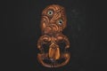 Wooden Maori Hei Tiki hand carved with paua shell eyes. New Zealand taonga. Royalty Free Stock Photo