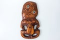 Wooden Maori Hei Tiki hand carved with paua shell eyes. New Zealand taonga. Royalty Free Stock Photo