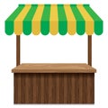 Wooden market stall with green and yellow awning.