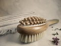 Wooden massage anti-cellulite brush on a linen towel close-up Royalty Free Stock Photo