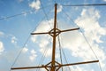 The wooden mast of an old ship on the background of blue sky.Going out to sea and adventures Royalty Free Stock Photo