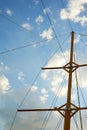 The wooden mast of an old ship on the background of blue sky.Going out to sea and adventures Royalty Free Stock Photo