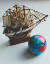 Wooden Masted Ship Model And Globe Isolated In Old Photo Style Royalty Free Stock Photo