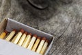 Wooden match in box on a wooden background. Fire safety concept, fire and tree. Close-up shot. Matches in an open matchbox on a Royalty Free Stock Photo