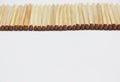 Wooden matches with a brown sulfur head on white background Royalty Free Stock Photo