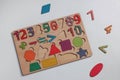 Wooden math game kit for children on white table, flat lay