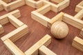 Wooden maze made with wood blocks and a wood sphere, finding labyrinth way out Royalty Free Stock Photo