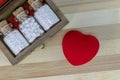 Wooden medicine box with homeopathic medicine glass bottles and a heart on wood background, Homeopathy for Healthy Heart concept