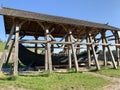 Wooden medieval boat under a canopy. An old wooden ship in the Kievan Rus park