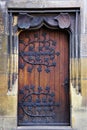 Wooden medieval door with cast iron leaves