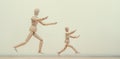 Wooden men mannequins run after each other or run away, play with children