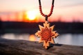 a wooden mentors talisman against the backdrop of a sunset