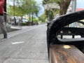 Wooden and metal bench on the sidewalk Royalty Free Stock Photo