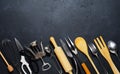 Wooden and metal kitchen utensils. Tools for cooking. Dark background. Flat lay. Copy space Royalty Free Stock Photo