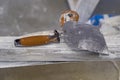 Plastering tools lying on a metal shelf in close up