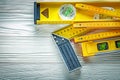 Wooden meter construction level try square on white board Royalty Free Stock Photo