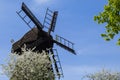 Wooden Mill on blue sky background. Old Windmill at dawn. Windmill farm. Rural landscape village on the hill in Trzew Royalty Free Stock Photo