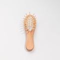Wooden mini bamboo hair brush for travel, beard or kids on white background. Small pocket brush Royalty Free Stock Photo