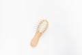 Wooden mini bamboo hair brush for travel, beard or kids on white background. Small pocket brush Royalty Free Stock Photo