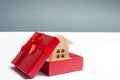 Wooden miniature house in a gift box. Housing as a gift. Win an apartment in the lottery. To inherit property. Holiday discounts.