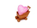 Wooden miniature shopping cart with heart isolated