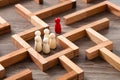 Wooden miniature at the start point of puzzle maze wood block. Leadership concept