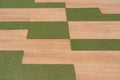 Wooden mix with artificial green glass square tiles floor background Royalty Free Stock Photo