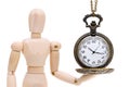 Wooden model dummy holding old clock watch