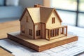 Wooden model house on blueprint at desk Royalty Free Stock Photo