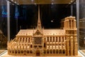 Wooden model of Notre Dame de Paris under glass dome side view