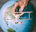 Wooden model vintage airplane fly near the Earth globe